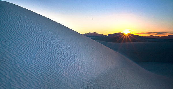 Photo: Dune, Mountain Range, and Sun - White Sands National Monument, New Mexico. Credits: Kevin Pfister
